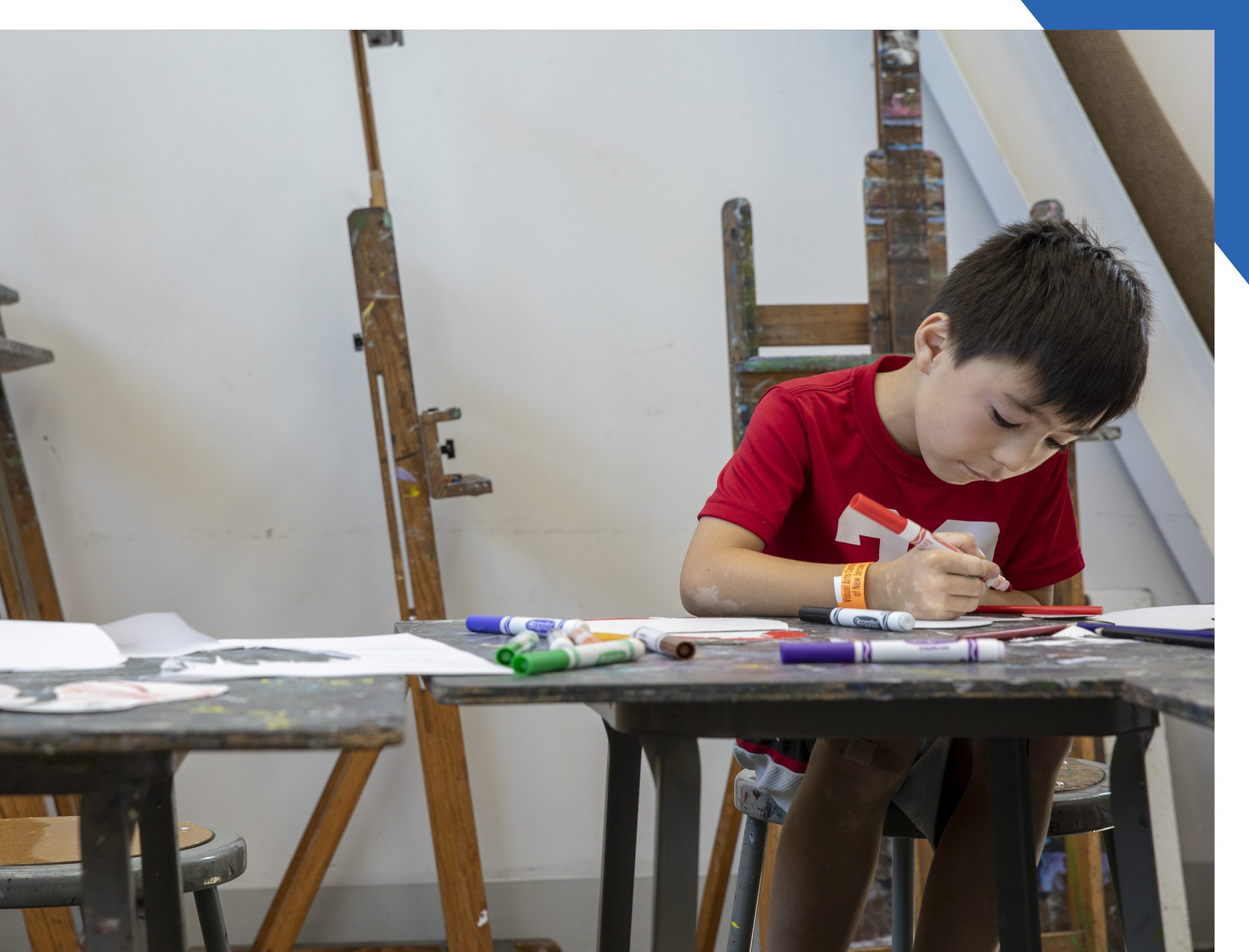 Child making art with markers
