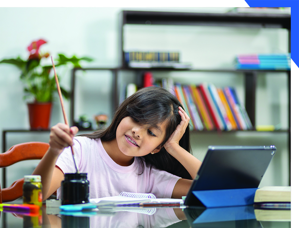 Child artist in front of a computer