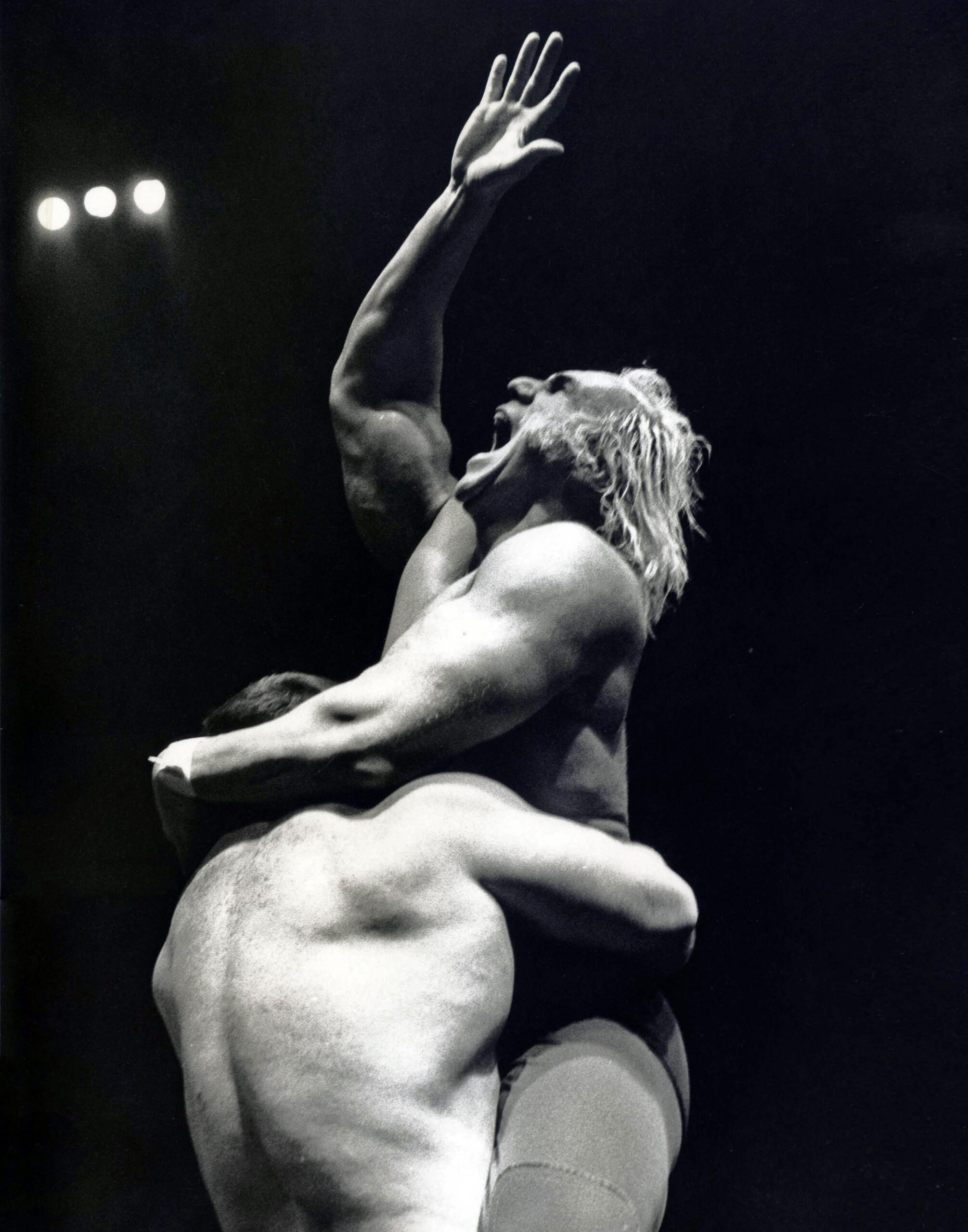 Superstar Billy Graham 2, 1977 Chromogenic print 10 x 8 inches. Shows two men, one holding the other up. The man on the top is yelling and holding his right arm up.