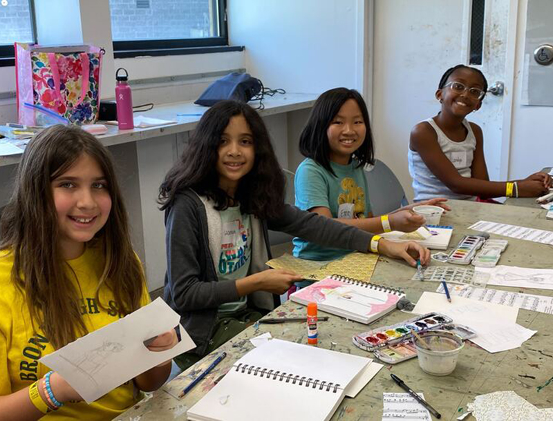 A group of four young girls doing various activities at Art Camp.