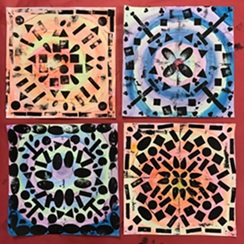 There are four snowy collagraphs made by printmaking. Each are filled with shapes and are very symmetrical. The top left and bottom right have warm colors while the top right and bottom left have cool colors.