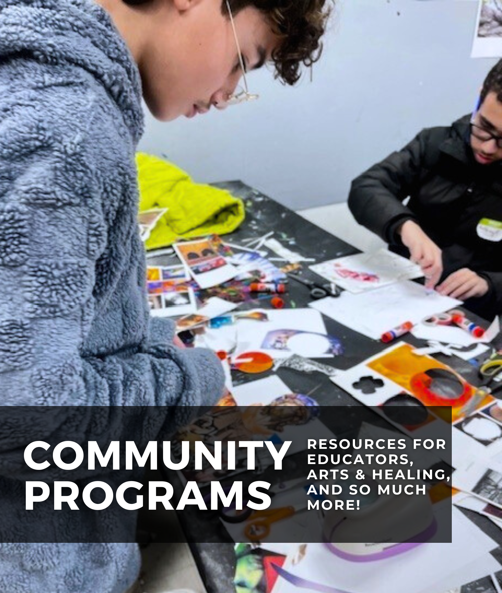Participants work at a table covered with collage materials, glue sticks, and scissors during a hands-on community art program.